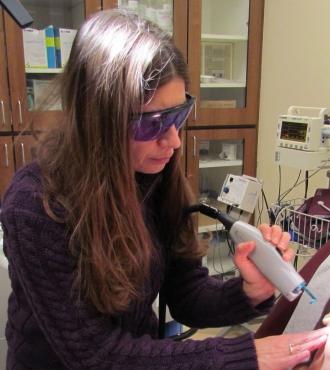 Woman performing laser treatment